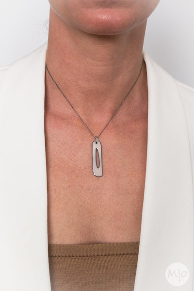 The Nudes Collection STANDING Pendant is an artfully inspired pendant creates a subtle texture on skin defined by a minimalist shape. The perfectly considered sterling silver bead chain is oxidized (blackened) to create a thin line and delicate drape around the neck.